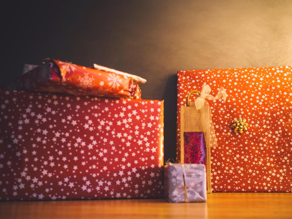 Wrapped Christmas presents under warm holiday lighting